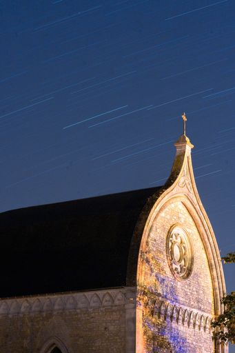 A vertical shot of the Chapel in Charente, France at night time