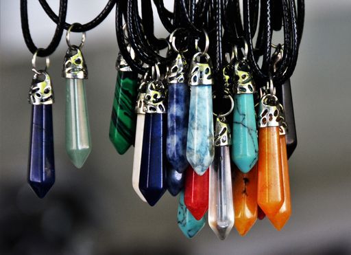 A closeup shot of hanginghandmade pendants made of semi-precious colorful stones