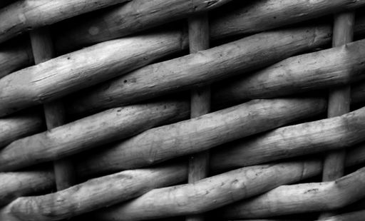 A closeup monochrome shot of a woven straw texture