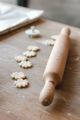 A vertical shot of the dough of pastry and a rolling pin