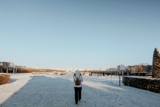 A young woman walking in the Grand Cascade of Peterhof, Russia in winter