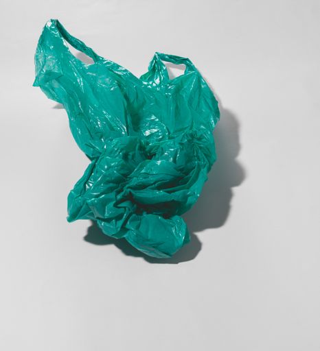 A green plastic bag isolated on a white background