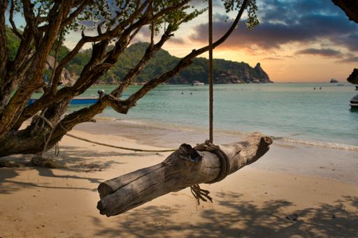 Swing in beautiful sunset at bay beach on island koh tao thailand having clear sand and water