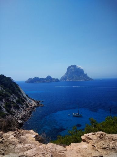 A vertical shot of the beach next to Ibiza and Es Vedra in the background