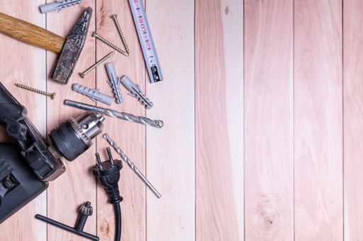 An electric drill with its small set on a wooden table