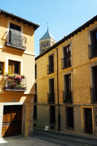 A vertical shot of short yellow buildings in Segovia, Spain
