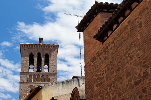 A bottom view shot of brick buildings and cloudy sky in the background in Toledo, Spain