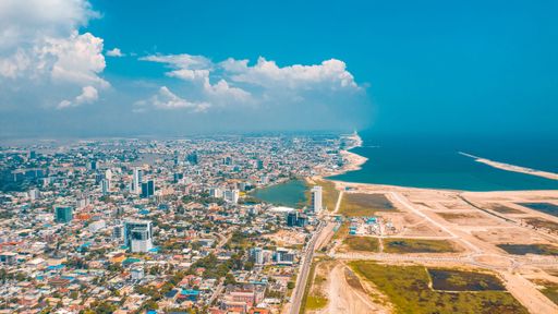 An aerial view of Lagos cityscape before the sea on a sunny day