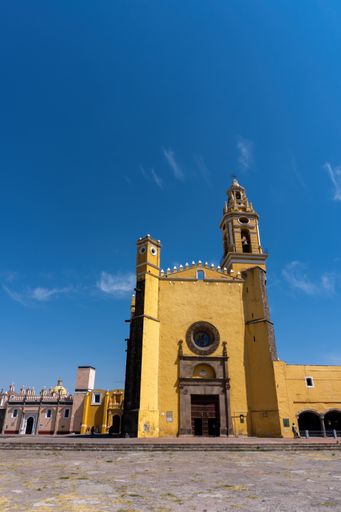 A daytime cloudscape behind historical San Gabriel Friary Catholic church in Cholula, Mexico