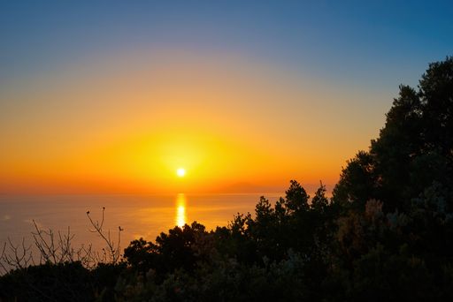 An amazing shot of the sunset over the sea on Skiathos island, Greece