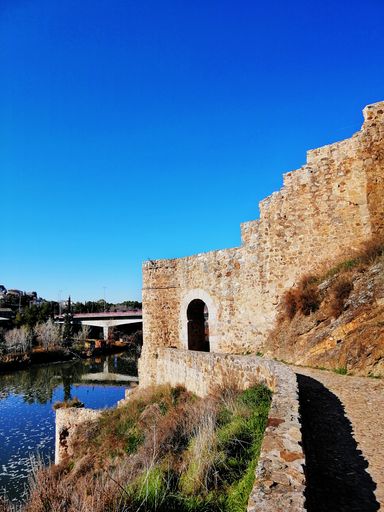 A beautiful shot of a walkway leading to an arch in Toledo, Spain