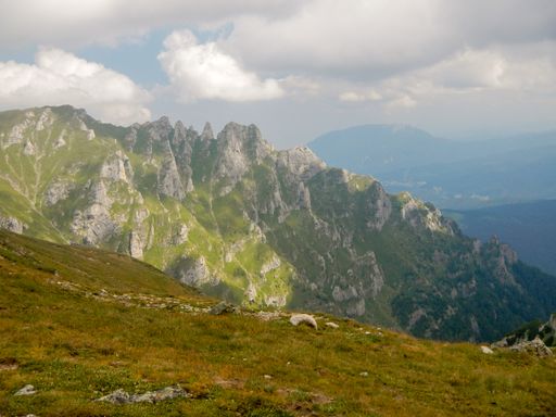 A beautiful view of the green Fagaras mountains against the cloudy sky in Romania