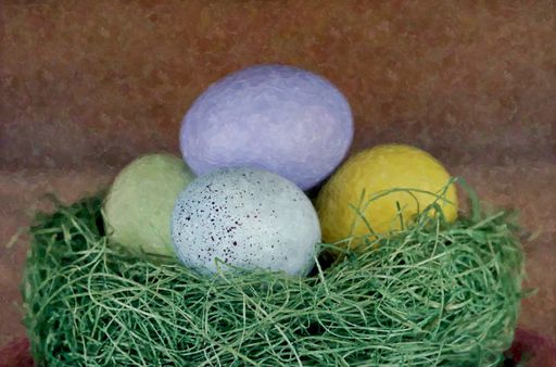 A closeup shot four pastel colored eggs in a green nest