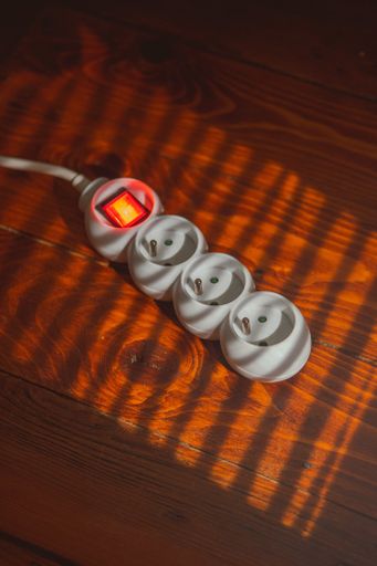 A closeup shot of a power strip on wooden background