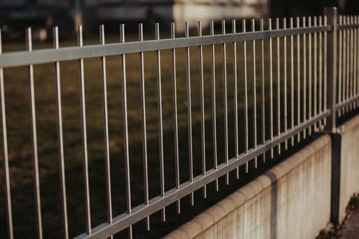 A black metal fencing around the park