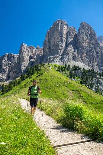 hiker with a backpack on his shoulders coming down from the mountains