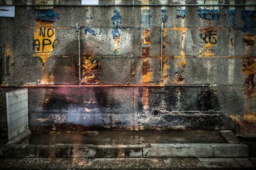 An old rusted wall with covered up graffiti