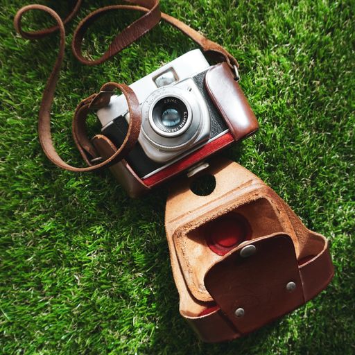 An overhead shot of a camera in case lying on the grass