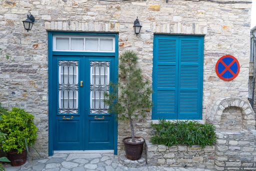 A beautiful traditional blue painted door with metallic fences in Cyprus