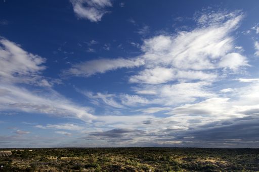 A panoramic shot of a  green mountains landscape under the blue sky