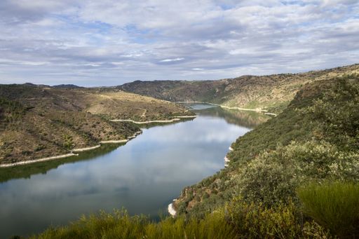 A beautiful sunny day in nature, where the river passes through the mountains under the blue sky