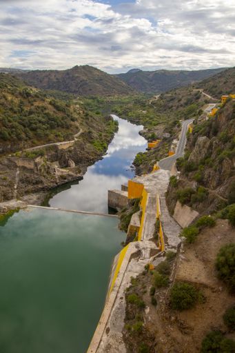 A high angle shot of a hydropower electric dam surrounded by mountains