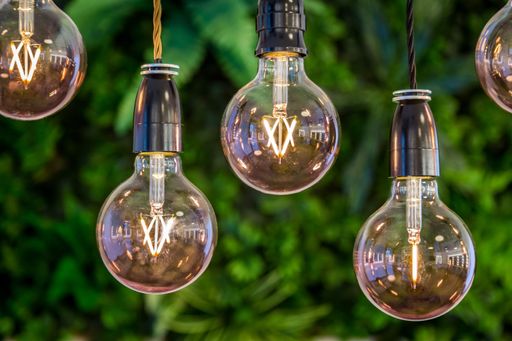 A selective focus shot of light bulbs hanging on the ceiling