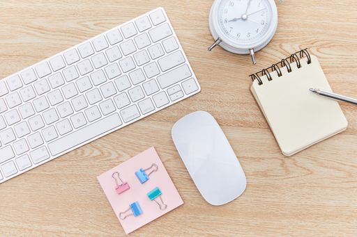 A closeup shot of the keyboard and notebook on the table