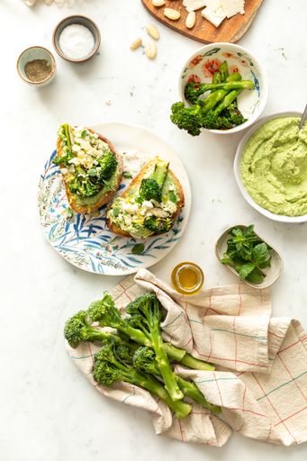 A top view of healthy vegan breakfast with broccoli, egg, sauces, and other ingredients