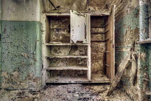 An old broken wardrobe in an abandoned ruined room