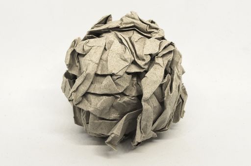 A crumpled piece of recycled paper isolated on a white background