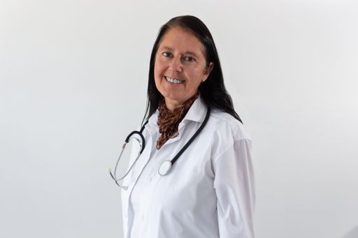 A happy smiling Caucasian female doctor with a stethoscope isolated on a white background
