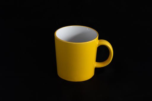 Empty yellow cup with white background
