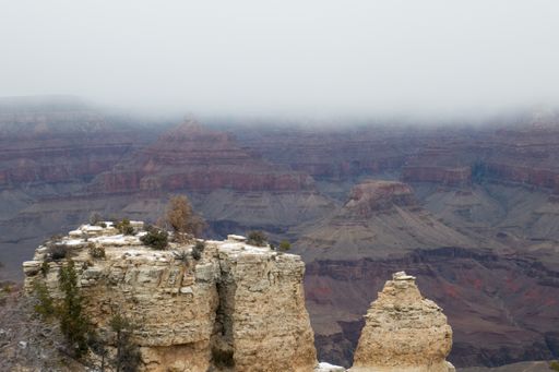 Look out over Grand Canyon rock formations in winter as snow cloud desecends
