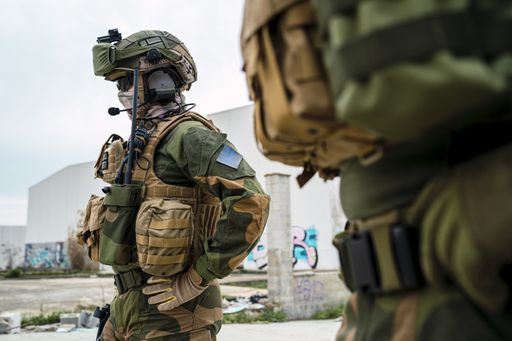 A shallow focus of special force soldiers in camouflage with guns during a mission outdoors