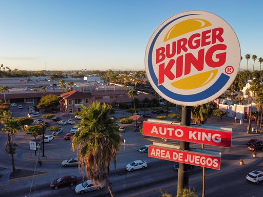 A closeup of a burger king billboard in downtown