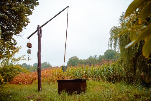 A beautiful shot of a well crane near cornfields in autumn