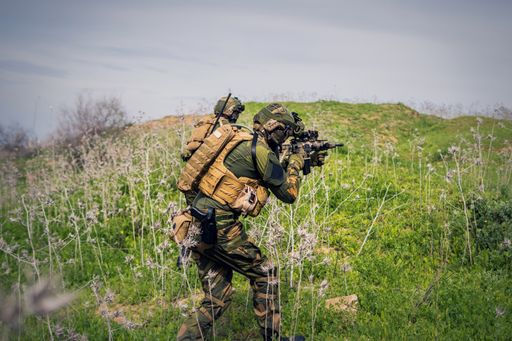 The special forces soldiers aiming with assault rifles on a military operation