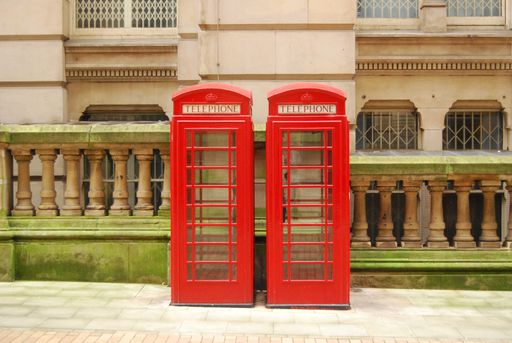 Two Red Telephone Kiosks in a side street.