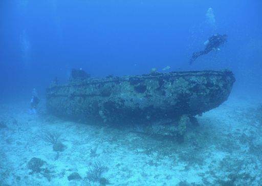 The scuba divers and old boat