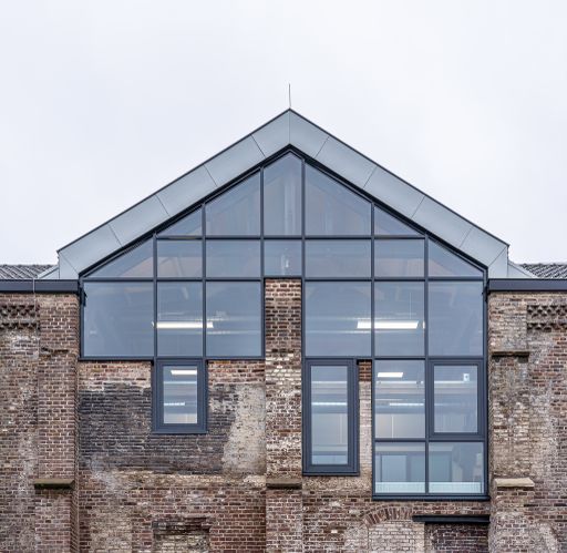 A great shot of a contemporary home with wide window panels and brick accent