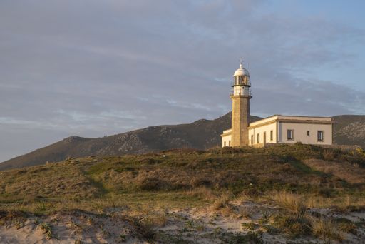 A beautiful view of the Larino lighthouse on the hill under the cloudy sky in Carnota, Galicia, Spain