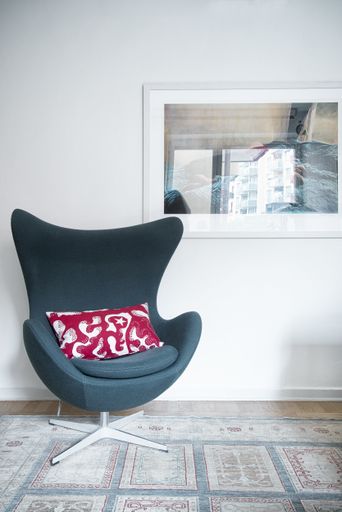 Danish designer Arne Jacobsen EGG Easy Chair on a rug with picture hanging on wall