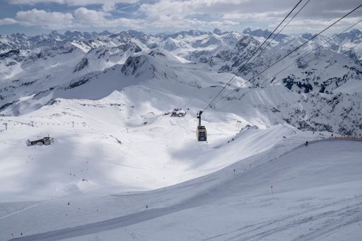 A wide shot of a cable cart in a snowy mountain