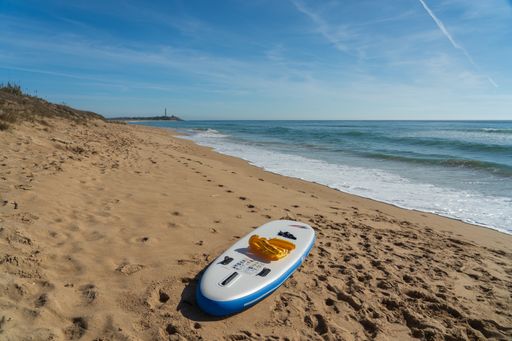 A beautiful shot of a sandy beach with a clear blue sky in the background in zahora spain