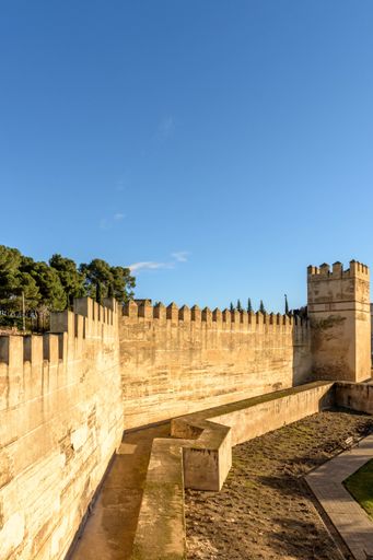 A vertical shot of the Badajoz Fortress under the sunlight and a blue sky in Spain