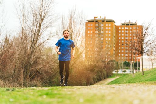 A young Caucasian Spanish male running in the morning in a park