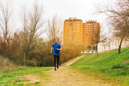 A young Caucasian Spanish male running in the morning in a park
