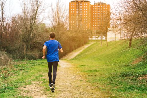 A young Caucasian Spanish male running in the morning in a park