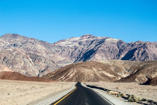 A shot of a  road  near the massive mountains in Death Valley National Park, California USA